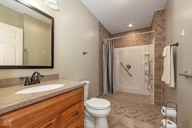 bathroom featuring toilet, a shower with curtain, vanity, and a textured ceiling