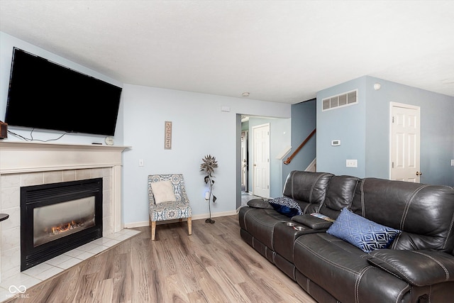 living room with a fireplace and light hardwood / wood-style flooring