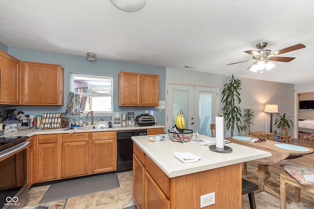 kitchen featuring sink, ceiling fan, a kitchen island, dishwasher, and electric range