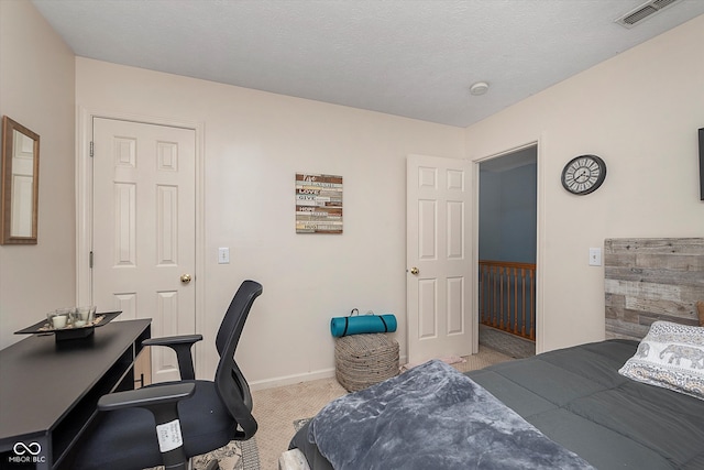 carpeted bedroom with a textured ceiling