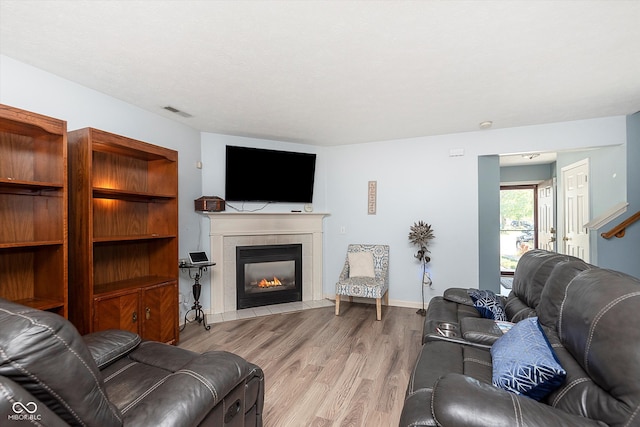 living room with a fireplace and light hardwood / wood-style flooring