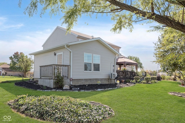 view of property exterior featuring a lawn and a gazebo