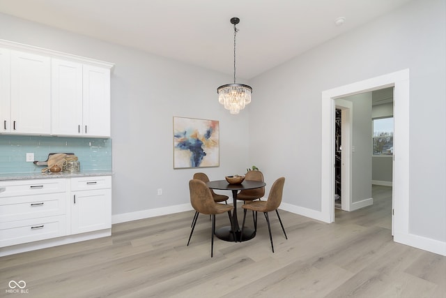 dining room featuring light hardwood / wood-style floors and an inviting chandelier