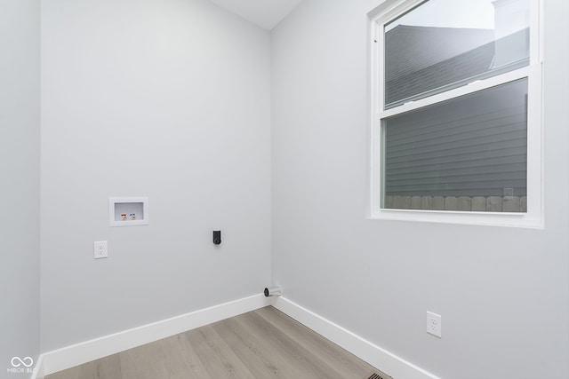 laundry room with electric dryer hookup, hookup for a washing machine, and light hardwood / wood-style flooring