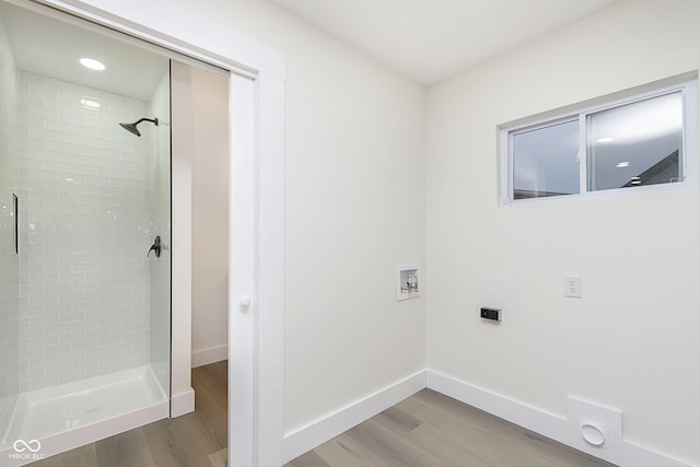 clothes washing area with washer hookup and wood-type flooring