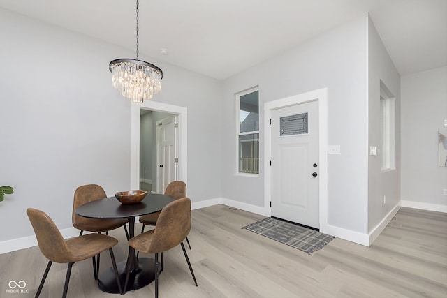 dining room with an inviting chandelier and light wood-type flooring