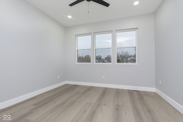 spare room with light wood-type flooring and ceiling fan