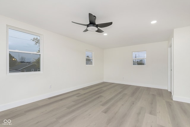 unfurnished room with plenty of natural light, ceiling fan, and light hardwood / wood-style flooring