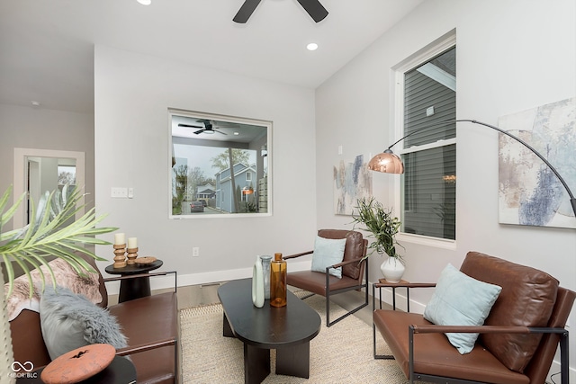 sitting room with hardwood / wood-style flooring and ceiling fan