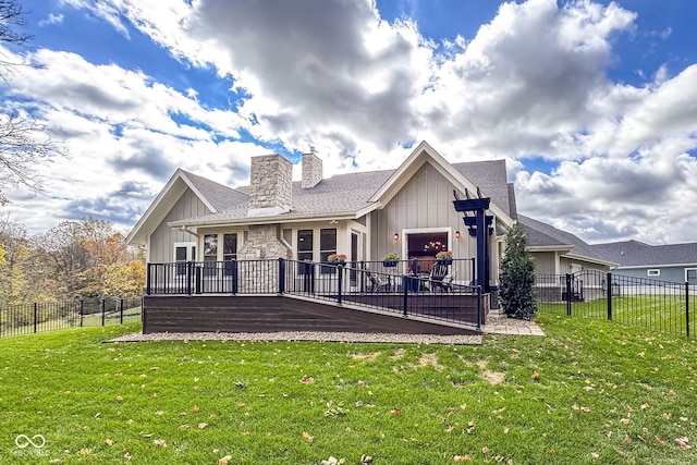 back of house with a wooden deck, a yard, and a garage