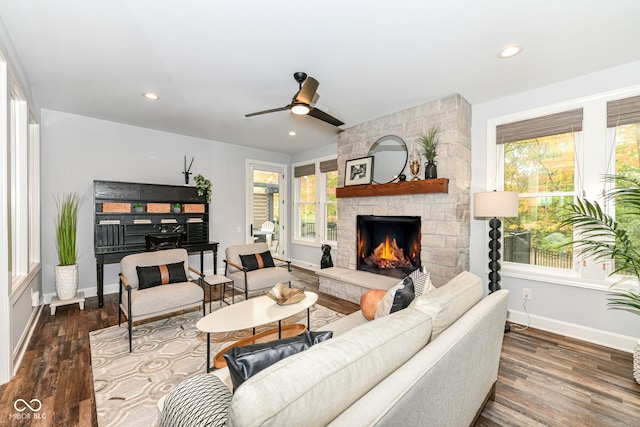 living room featuring hardwood / wood-style floors, a fireplace, and ceiling fan