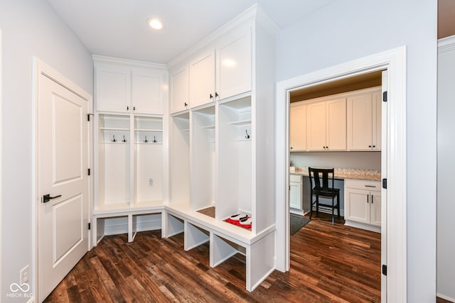 mudroom featuring built in desk and dark hardwood / wood-style floors