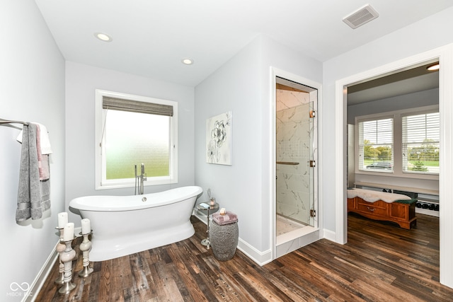 bathroom with plus walk in shower and hardwood / wood-style floors