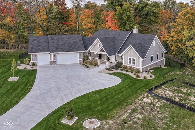 view of front of home featuring a front yard and a garage