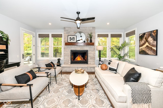 living room featuring light hardwood / wood-style floors, a healthy amount of sunlight, and a fireplace