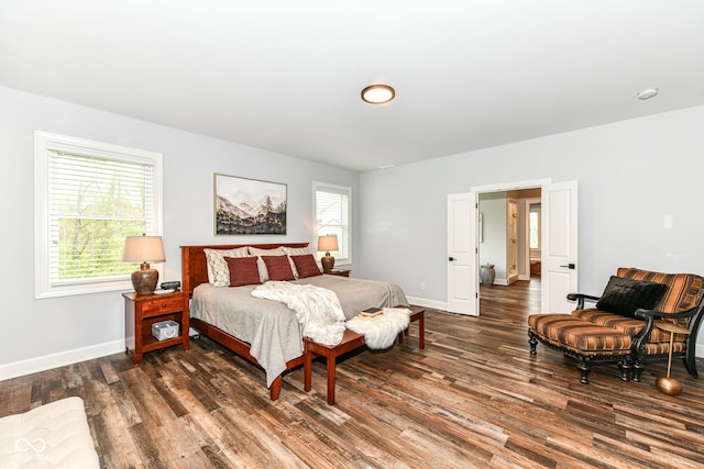 bedroom featuring multiple windows and dark hardwood / wood-style floors