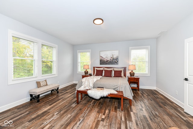 bedroom with dark wood-type flooring