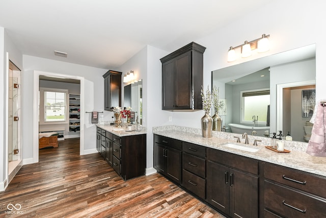 bathroom with vanity, hardwood / wood-style flooring, and a bathing tub