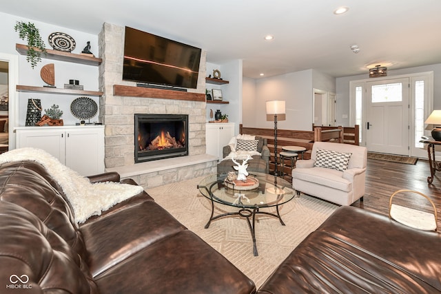 living room with wood-type flooring and a fireplace