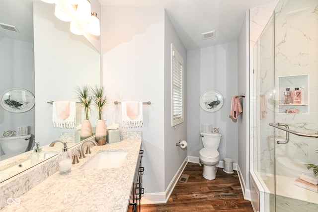 bathroom with vanity, wood-type flooring, toilet, and an enclosed shower