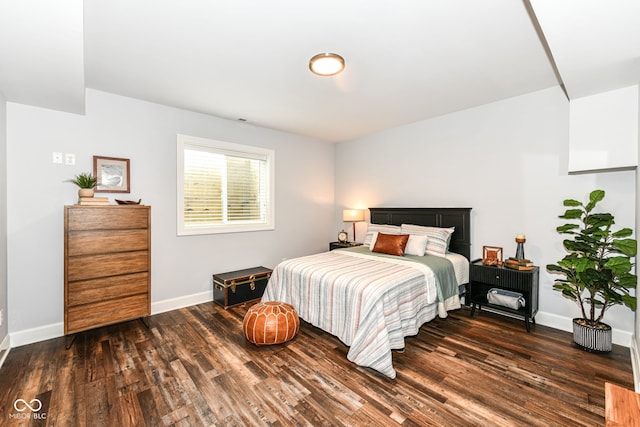 bedroom with dark hardwood / wood-style floors