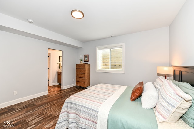 bedroom with dark hardwood / wood-style floors