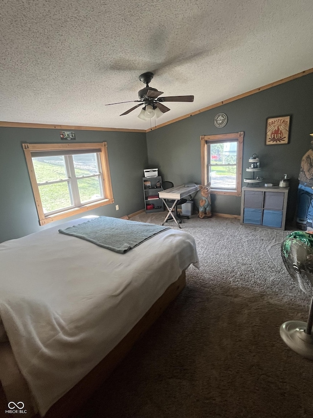 carpeted bedroom featuring multiple windows, ceiling fan, and ornamental molding