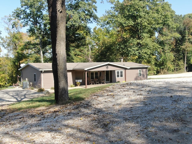 ranch-style house featuring central AC unit and a patio area