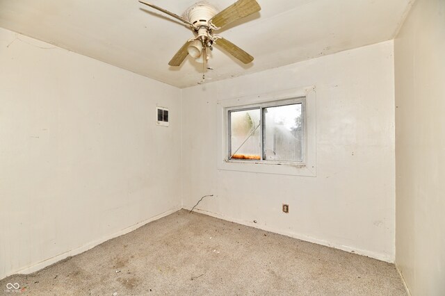 spare room featuring ceiling fan and light colored carpet