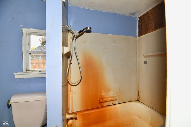 interior details featuring tub / shower combination and toilet