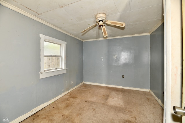 carpeted empty room featuring crown molding and ceiling fan