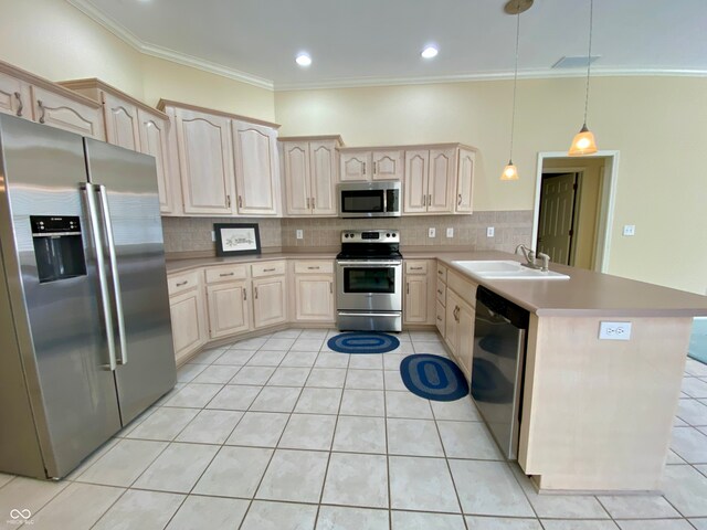 kitchen featuring light brown cabinets, kitchen peninsula, hanging light fixtures, appliances with stainless steel finishes, and sink