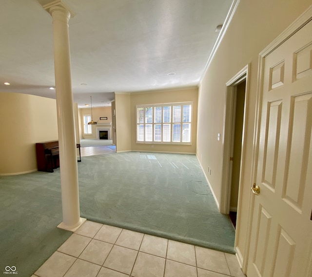 unfurnished living room featuring light colored carpet and ornate columns