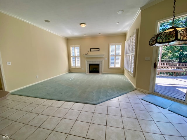 unfurnished living room with crown molding, light carpet, and a tile fireplace