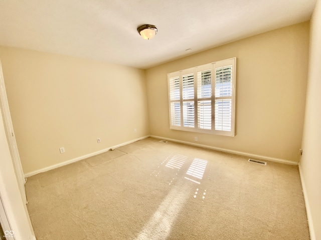 spare room with light colored carpet