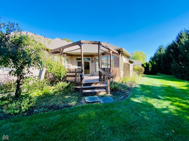 back of property featuring a yard and a wooden deck