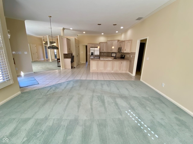 unfurnished living room featuring light carpet and ornamental molding