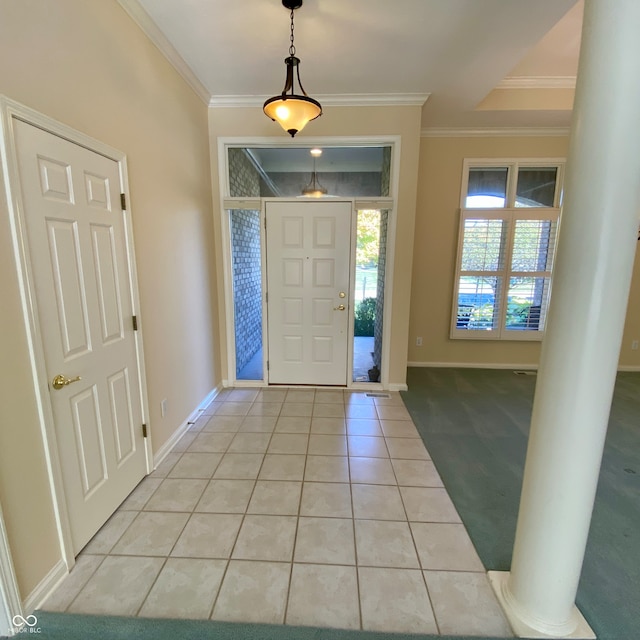 tiled entryway featuring ornamental molding and ornate columns