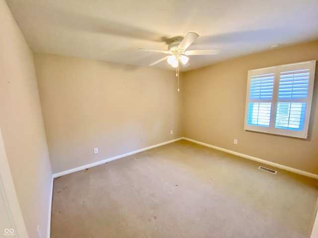 empty room with ceiling fan and carpet