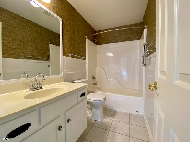 full bathroom with bathtub / shower combination, tile walls, toilet, vanity, and tile patterned flooring