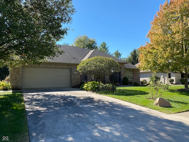 view of front of property with a front yard and a garage