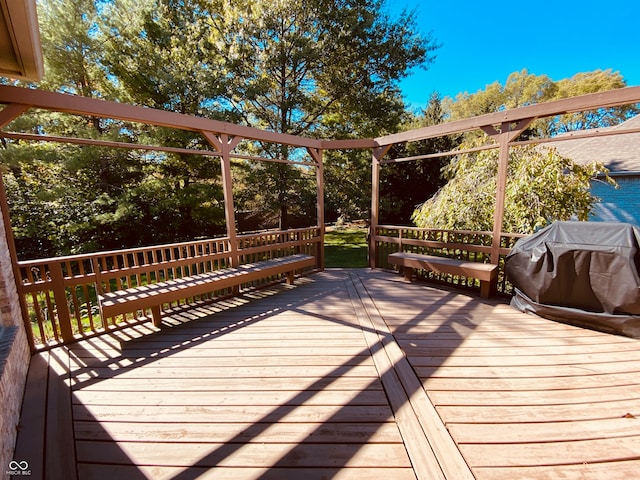 wooden deck with a grill