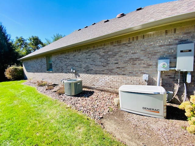 view of side of home with central air condition unit and a yard