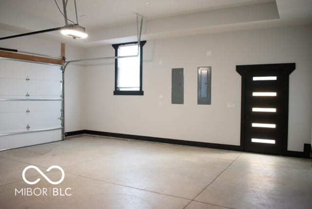 garage featuring electric panel and a garage door opener