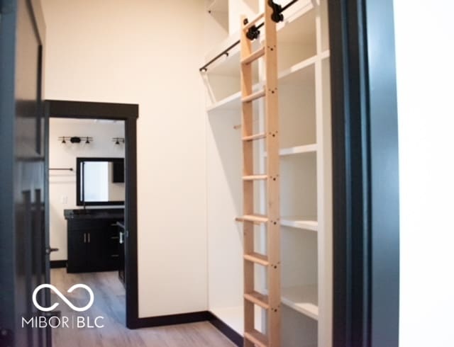 spacious closet featuring hardwood / wood-style flooring