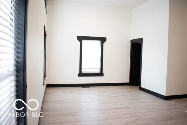 spare room with light wood-type flooring