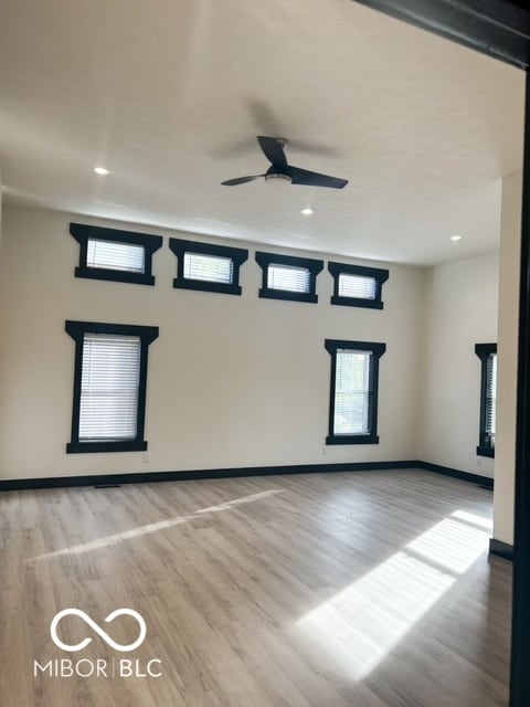 spare room with light hardwood / wood-style floors and ceiling fan