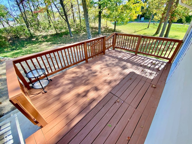 wooden deck with a lawn