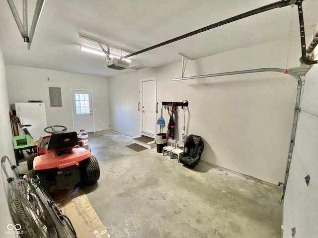 garage featuring white refrigerator, electric panel, and a garage door opener