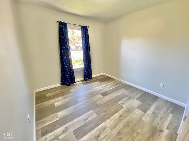 unfurnished room with hardwood / wood-style floors